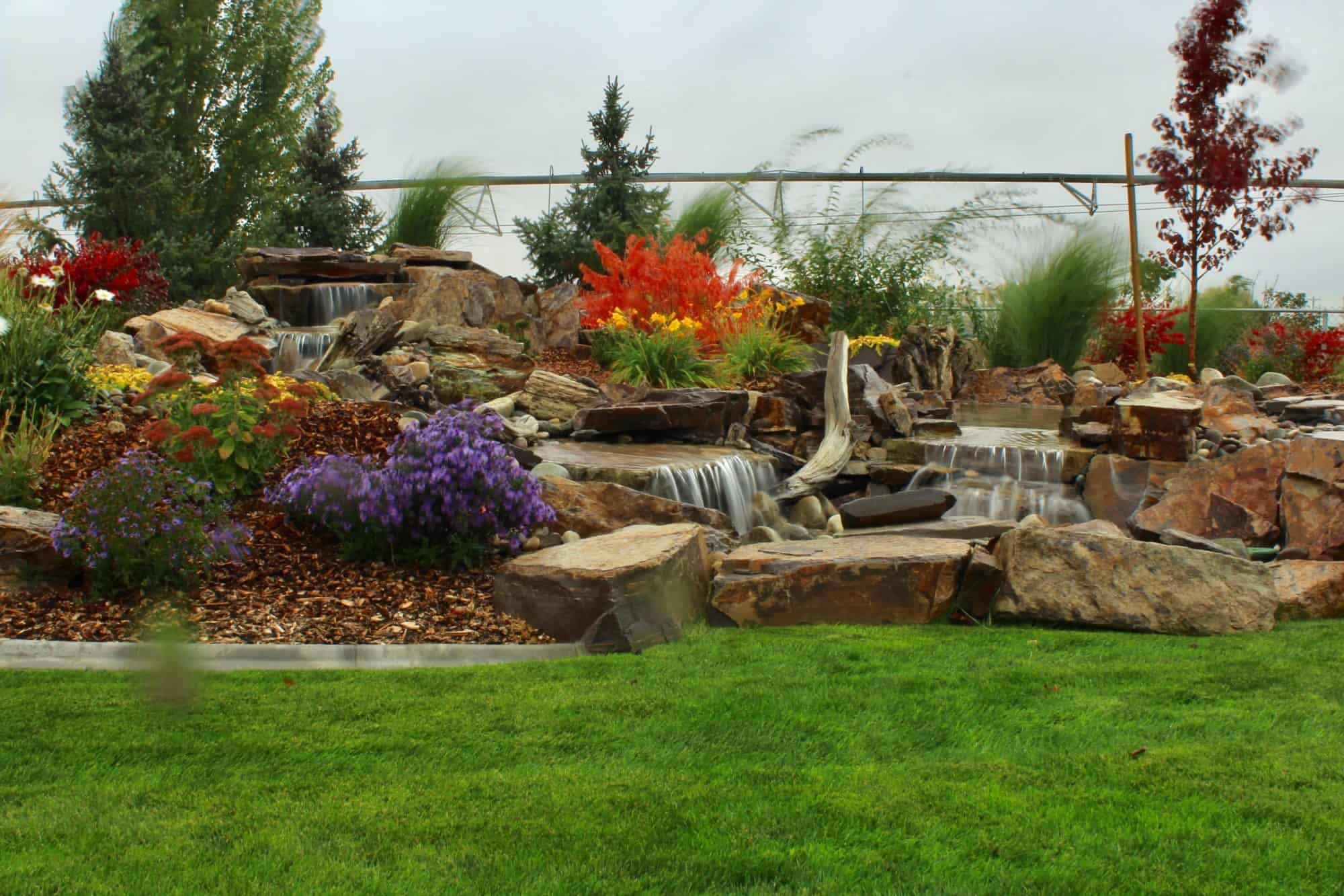 Waterfall over rocks with plants feature planned as a part of a residential landscaping project in Twin Falls, ID